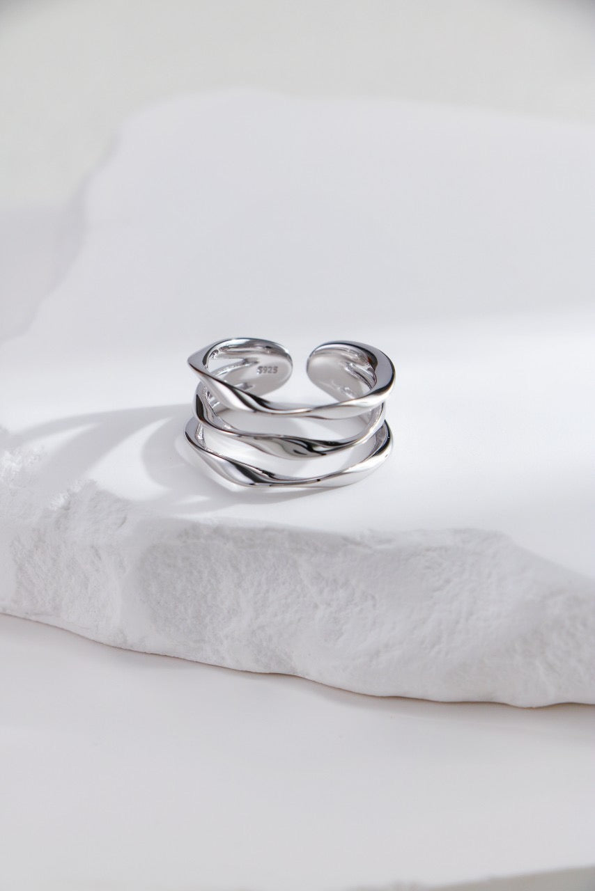 Silver ring on a white pillow