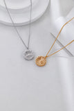Two necklaces with circular pendants on a light gray background