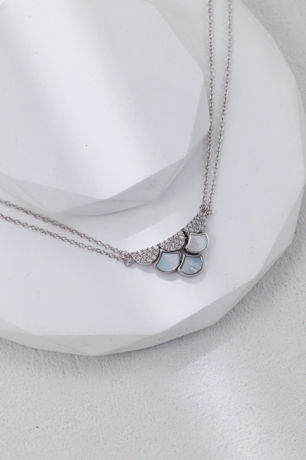 Necklace with heart-shaped pendants on a white surface
