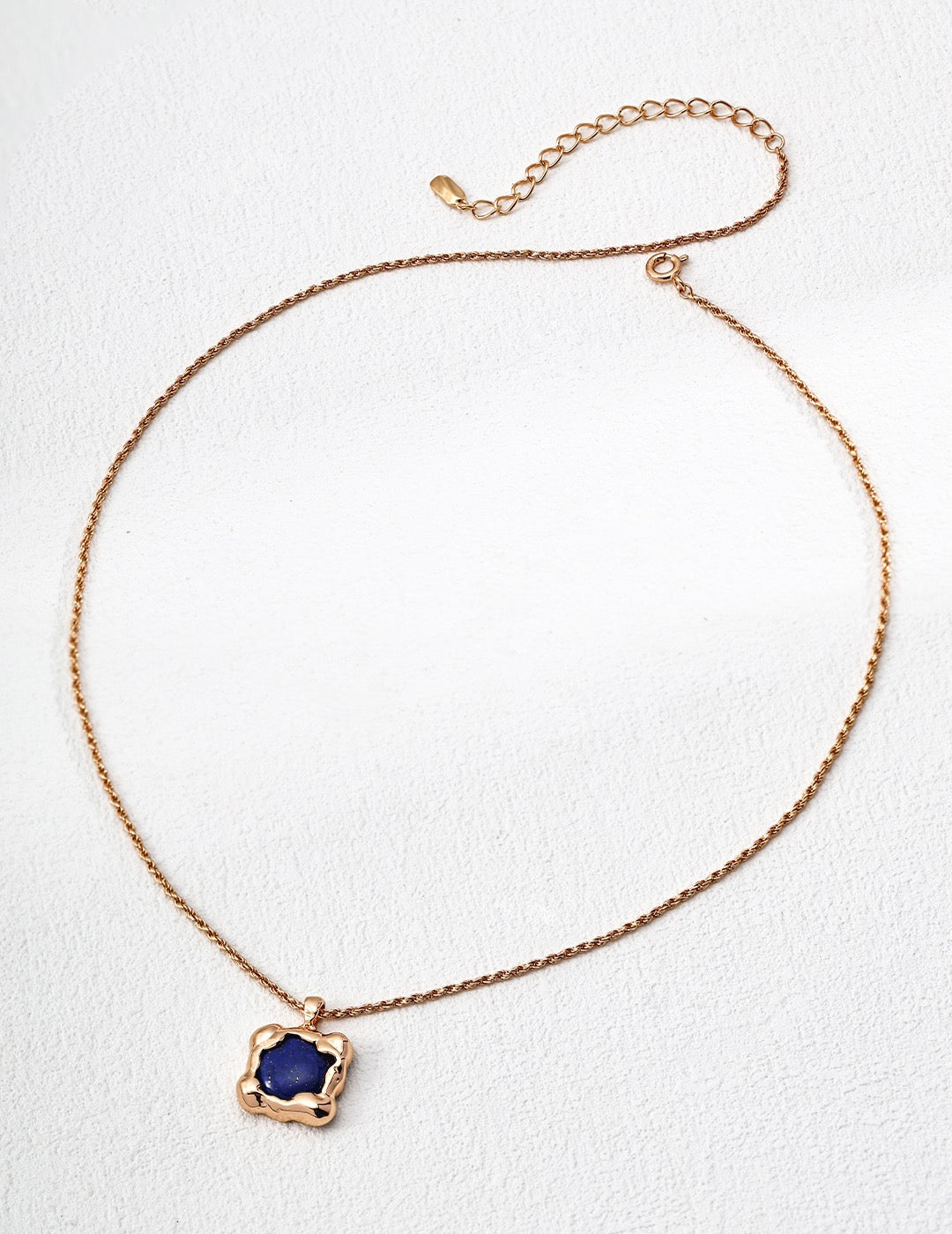 Necklace with a blue pendant on a white background