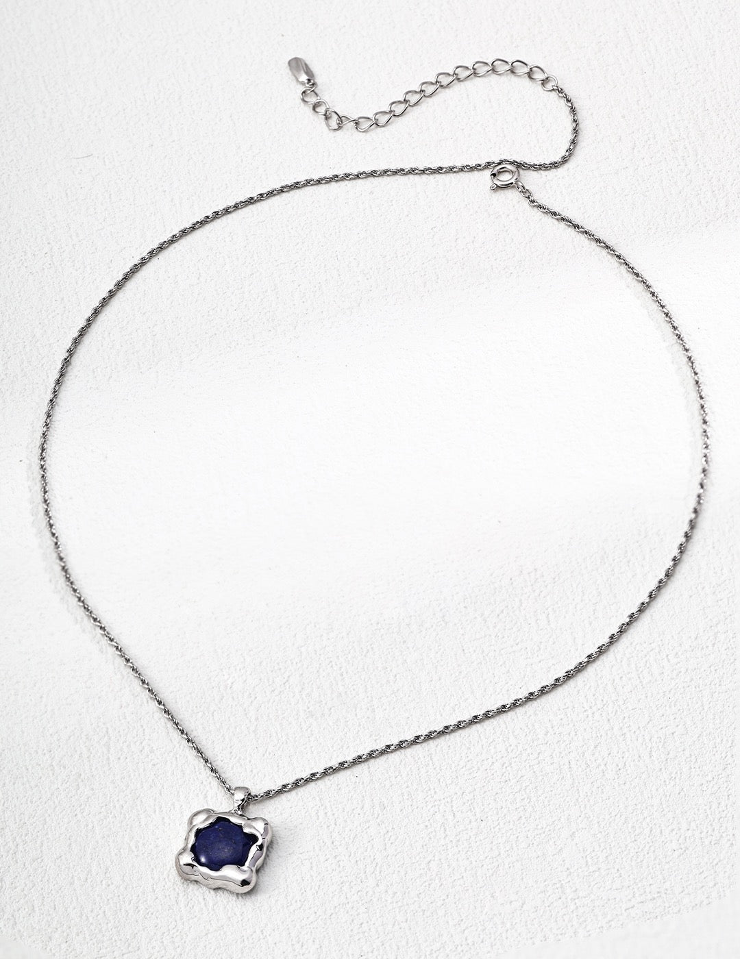 Necklace with a blue pendant on a white background