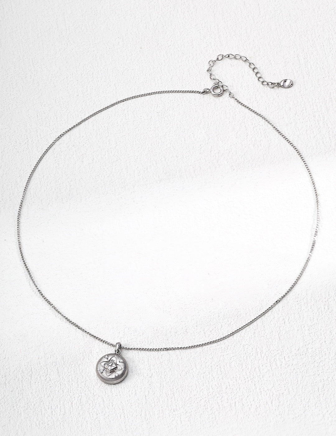 Silver necklace with a pendant on a white background