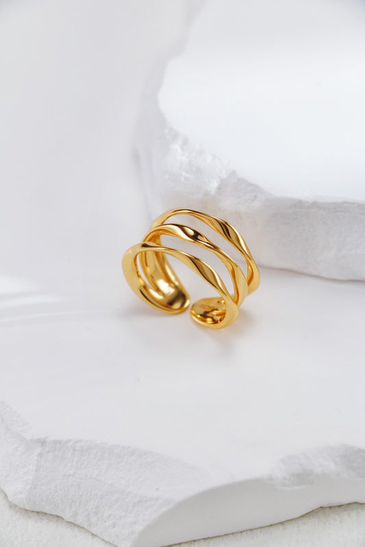 Gold ring on a white fabric background