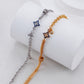 Two star-shaped bracelet options on a white cylindrical stand.
