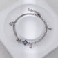 Silver bracelet with star-shaped charm on a white surface