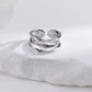 Silver ring on a white pillow