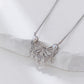 Silver necklace with butterfly design and pearls on a white background