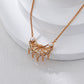 Gold necklace with a decorative pendant on a white surface