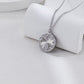 Silver necklace with a round pendant on a white surface
