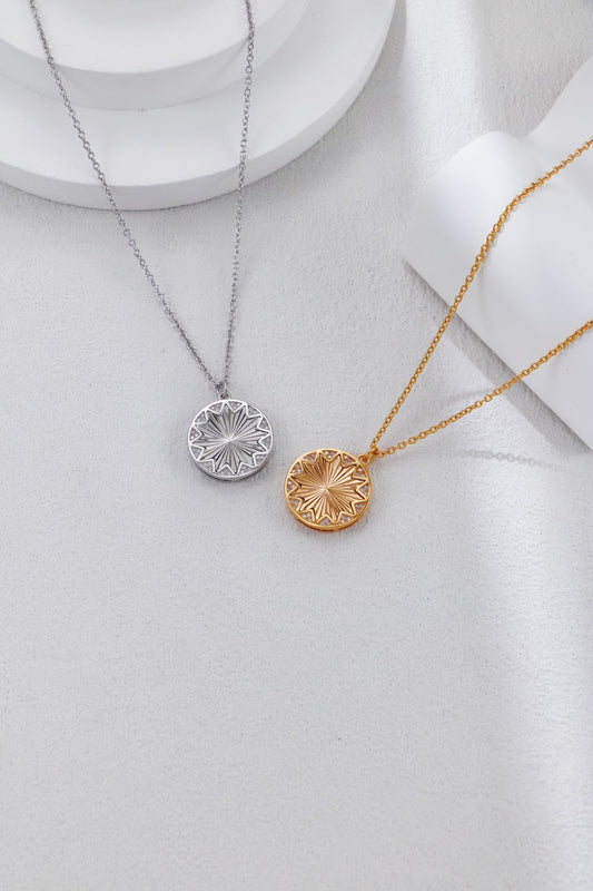 Two necklaces with circular pendants on a light gray background