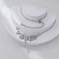 Silver necklace with floral design on a white stand