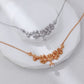 Two necklaces, one silver and one gold, on a white surface.