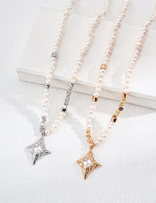 Three pearl necklaces with star-shaped pendants in silver, gold, and rose gold on a white surface.