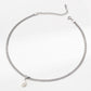 Silver necklace with a pearl pendant on a white background