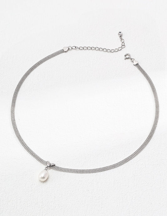 Silver necklace with a pearl pendant on a white background