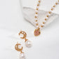 Pearl necklace and earrings on a white background