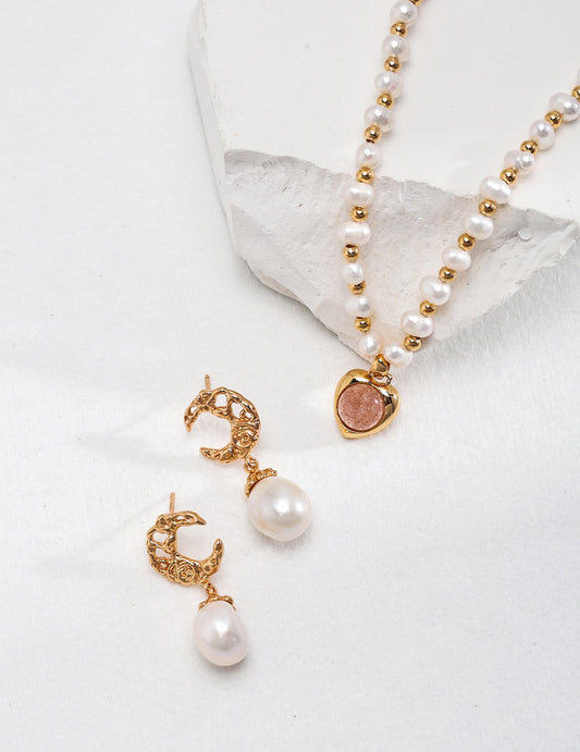Pearl necklace and earrings on a white background