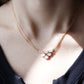 Necklace with a floral pendant worn by a person