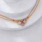 Gold necklaces on a white surface