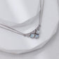 Necklace with heart-shaped pendants on a white surface