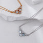 Two necklaces on a white fabric background