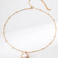 Gold necklace with a pendant on a white background