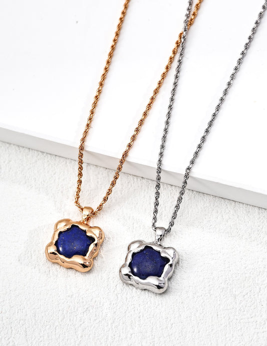 Two necklaces with blue pendants on rose gold and silver chains against a white background.