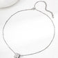 Silver necklace with a round pendant on a white background