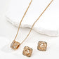 Gold necklace and earrings on a white surface