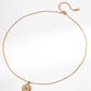 Rose gold necklace with a pendant on a white background