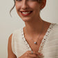 Woman wearing a white crochet top with a neutral background