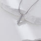 Silver necklace with a star-shaped pendant on a white fabric background