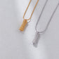 Two necklaces, one gold and one silver, on a light gray background.