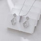 Silver jewelry set on a white fabric background