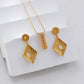 Gold earrings on a white surface